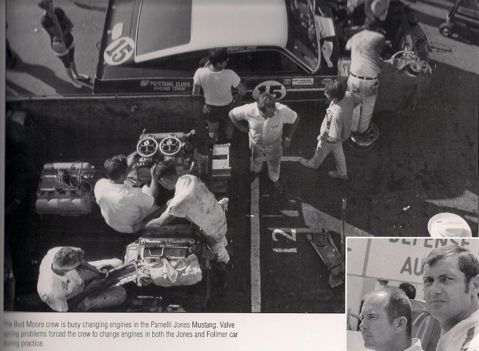 Racing team members work on engines next to a race car with number 15. A smaller inset shows two men