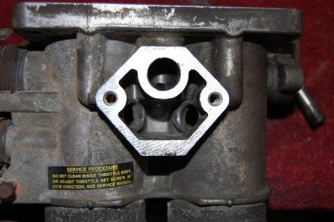1994 Ford Bronco - Throttle body with a service procedure label indicating not to clean inside or adjust the throttle set screw.