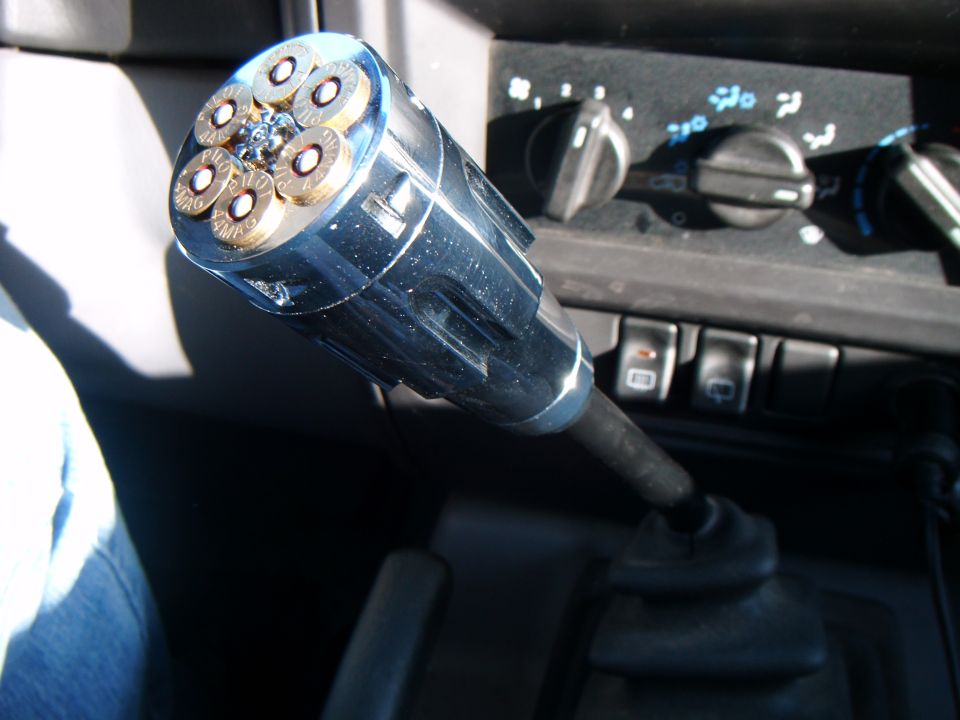 Chrome gear shift knob with six bullet casings, center console with climate controls and buttons