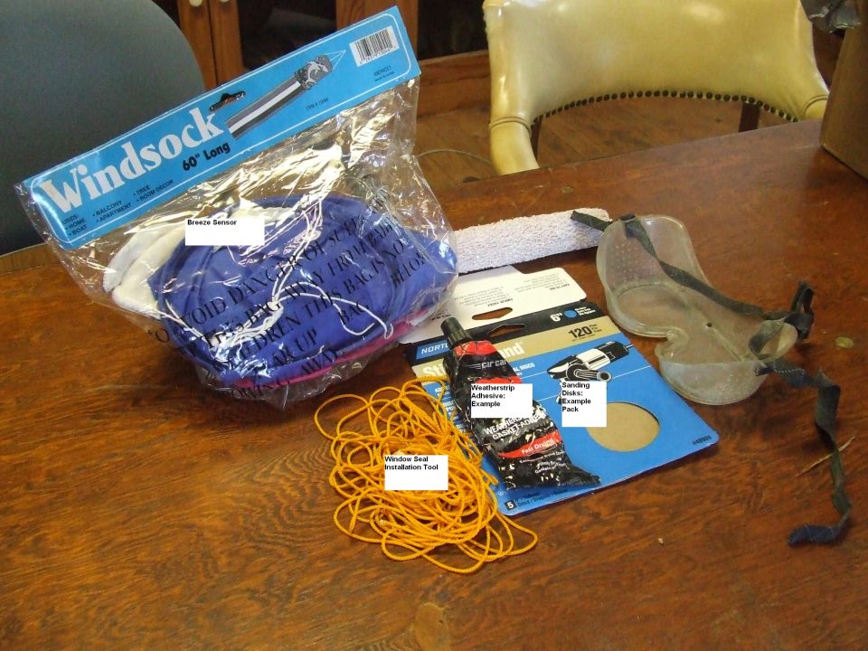 Windshield seal, adhesive, and installation tool on a wooden table