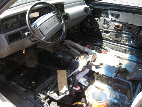 1990 Lincoln Mark VII - The interior of a Lincoln Mark VII is shown with its components disassembled for repair or modification.