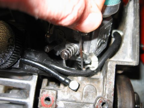 1992 Ford Bronco - Close-up of carburetor linkage being adjusted.