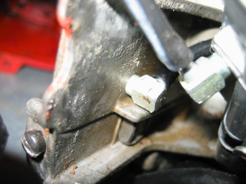1992 Ford Bronco - A detailed view of a mechanical part, showing bolts and hoses connected to a metal surface.