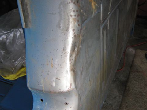 1977 Ford F-150 - Detail of a truck's fender and door edge, showing signs of wear and repair.