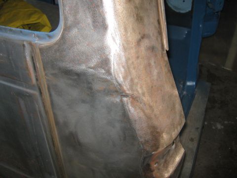 1977 Ford F-150 - This photo shows a section of a truck's body panel undergoing repair, revealing rust and damage.