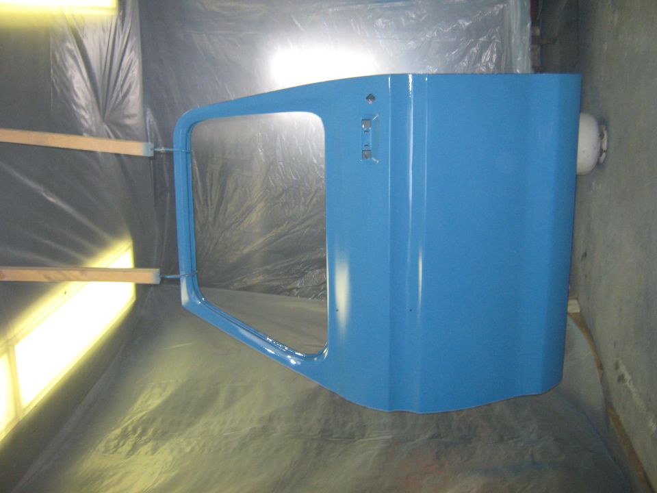 Blue truck door in spray booth