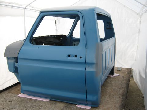 1977 Ford F-150 - This 1977 Ford F-150 cab and bed is shown in a tent, likely undergoing restoration or preparation for paint.