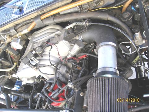 1994 Ford Bronco - Close-up of an engine bay an aftermarket air intake system and various engine components. A date stamp reads 03/14/2010.