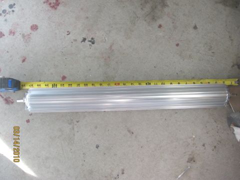 1994 Ford Bronco - Aluminum heat sink measured with a tape measure on a concrete surface.