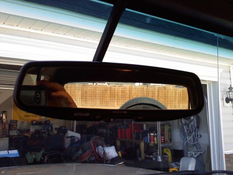 1992 Ford Bronco - Reflection of a spare tire in the rearview mirror of a 1992 Ford Bronco.
