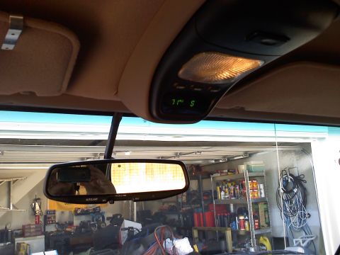 1992 Ford Bronco - The interior overhead console displays the temperature and another indicator, with a reflection of the garage visible in the rearview mirro…
