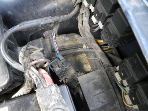 1993 Dodge Grand Caravan - Engine compartment wiring and fuse box show signs of wear and tear.