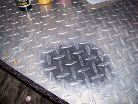 1978 Ford F-150 - Close-up of a diamond plate metal surface, showing wear and a dark stain.