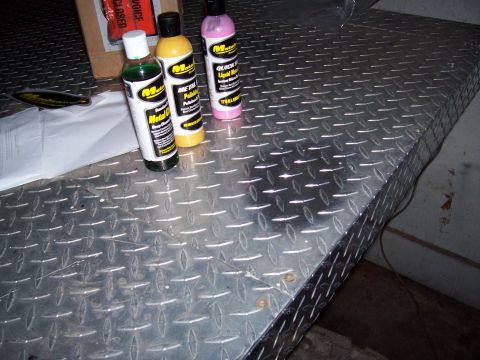 1978 Ford F-150 - Metal polish bottles sit on a diamond plate surface next to a box and some paper.