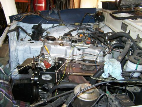 1988 Suzuki Samurai - The engine bay of a vehicle is shown, with various components and wiring visible. A watermark for SUPERMOTORS is present at the bottom.