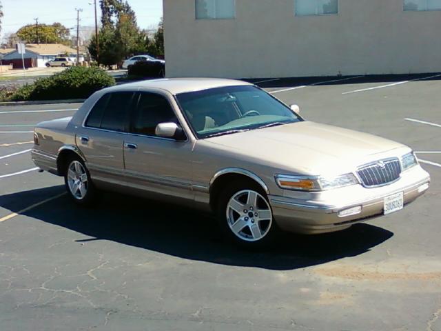 Gold 1997 Mercury Grand Marquis parked in a lot