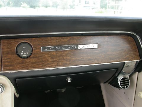 1968 Mercury Cougar - Interior view of a 1968 Mercury Cougar dashboard, highlighting the wood grain trim and an oil pressure gauge.