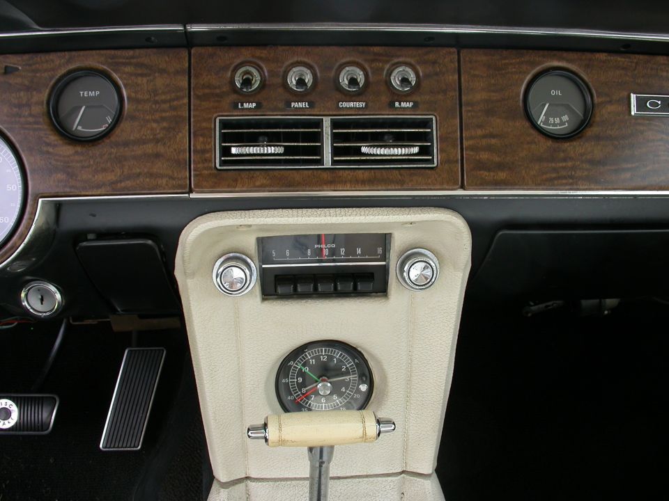 1968 Mercury Cougar interior dashboard with wood grain trim, clock, and gauges