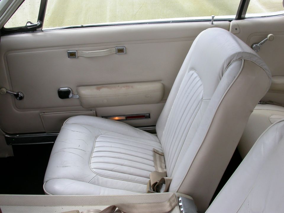 1968 Mercury Cougar interior with white vinyl seats and door panel
