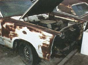 1967 Mercury Cyclone - This car shows significant rust damage and has its hood open, revealing the engine compartment.