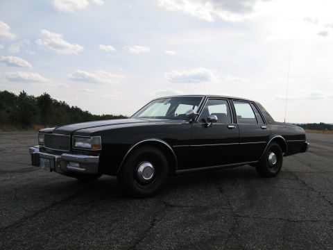 1991 Ford Crown Victoria LTD - This black sedan has a distinctive grille and body style from the early 1980s.