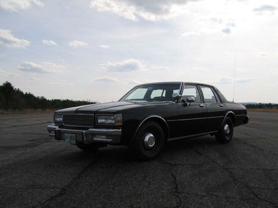 Black sedan, 3/4 front view. License plate reads 298 6968