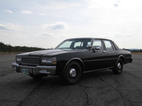 1991 Ford Crown Victoria LTD - This black sedan appears to be from the early 1980s, not a 1991 model.