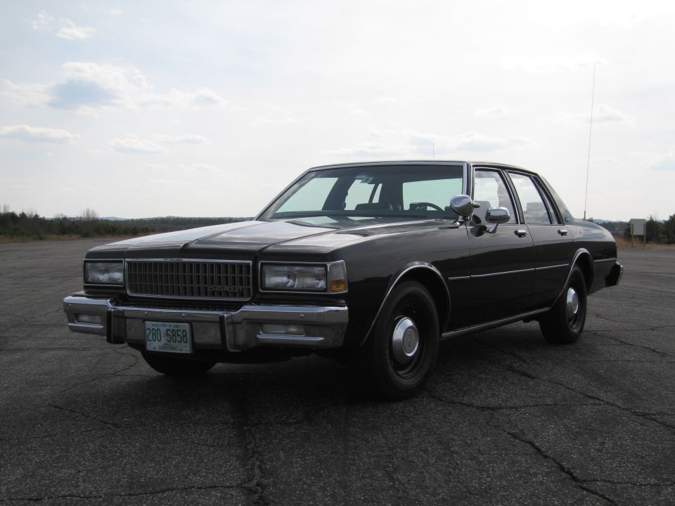 Black sedan with chrome grille and license plate 280 5858