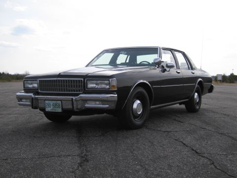 1991 Ford LTD Crown Victoria - This black sedan appears to be a Chevrolet Caprice from the early 1980s, not a 1991 Ford Crown Victoria.