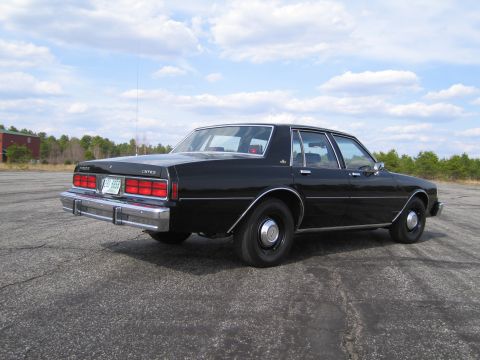 1991 Ford LTD Crown Victoria - This black sedan has a distinctive boxy body style and chrome accents.