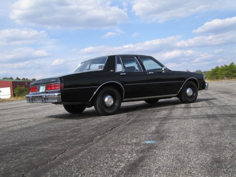 1991 Ford LTD Crown Victoria - This black sedan's body style suggests a 1980s model, not a 1991 Ford Crown Victoria LTD.