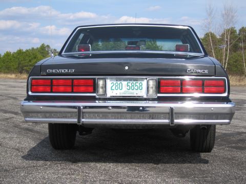 1991 Ford LTD Crown Victoria - This Chevrolet Caprice features a classic rear design with prominent taillights and a chrome bumper.