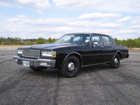 1991 Ford LTD Crown Victoria - This sedan's boxy body style and grille indicate it is from the early 1980s, not a 1991 model.