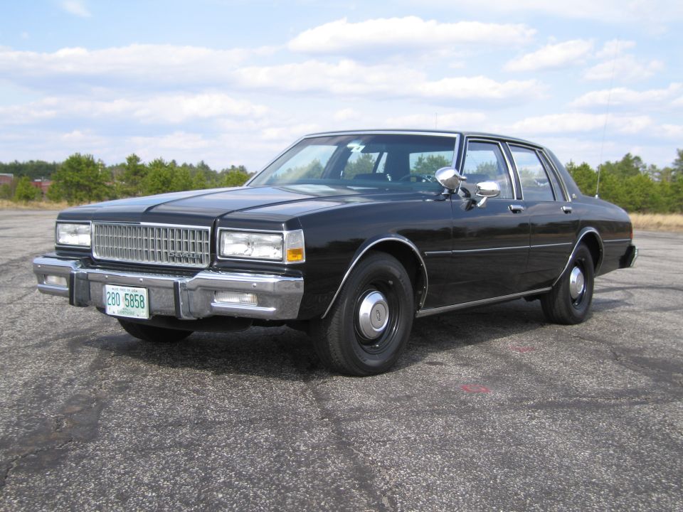 Black 1980s Chevrolet Caprice sedan parked on asphalt lot