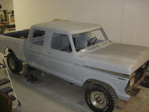1979 Ford F-250 - This crew cab pickup truck is in primer, suggesting it is undergoing restoration or preparation for a new paint job.