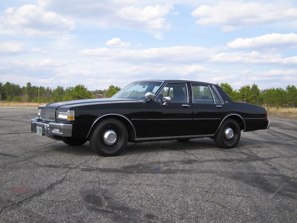 Black sedan, side view, steel wheels