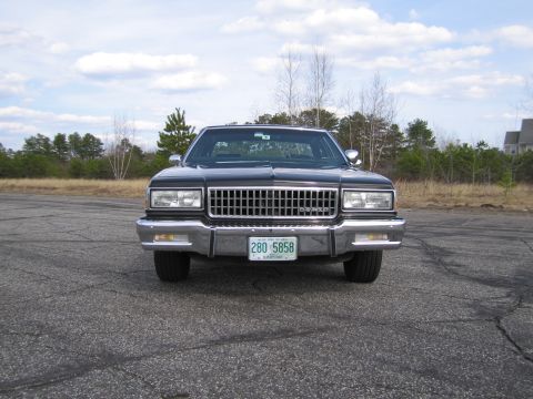 1991 Ford LTD Crown Victoria - Front view of a black sedan with a prominent chrome grille and a license plate reading 280 5858.