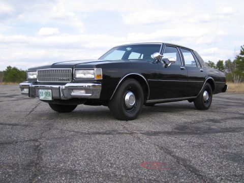 1991 Ford LTD Crown Victoria - This black sedan's body style suggests a model year in the early 1980s, not 1991.