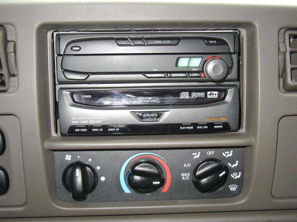 Tan dash with Alpine head unit, DVA-5205 DVD player, and three climate control knobs.