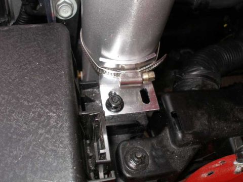 2010 Hyundai Genesis - A close-up view of a vehicle's engine intake system, showing a metal pipe secured with a clamp.