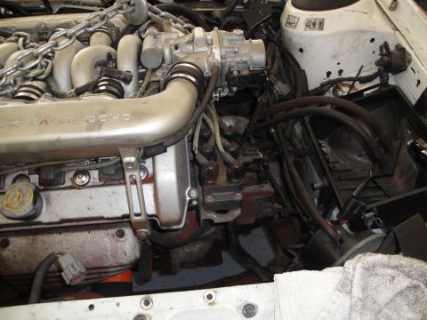 1989 Ford Taurus - Close-up view of an engine bay, showing the intake manifold and various engine components.