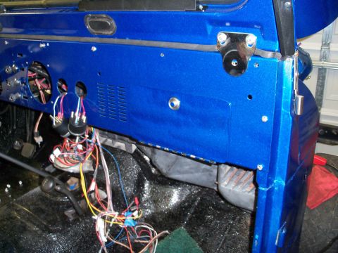 1978 Jeep CJ5 - The interior of a vehicle shows a blue dashboard with a complex wiring harness and exposed components.
