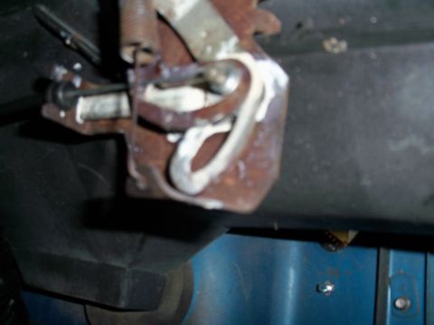 1978 Jeep CJ5 - Close-up of a rusted metal linkage mechanism with a spring and bolt.