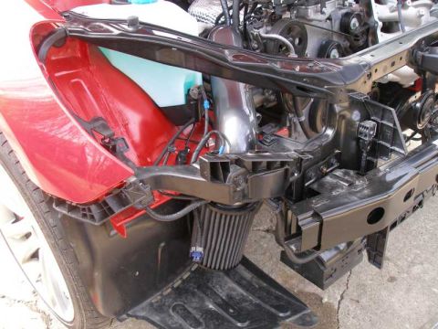 2010 Hyundai Genesis - Close-up view of a car's engine bay, showing the front fender and various mechanical parts.