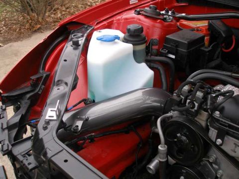 2010 Hyundai Genesis - Close-up view of an engine bay, showing an intake tube and windshield washer fluid reservoir.