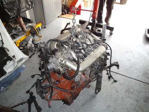 1989 Ford Taurus - Engine assembly being worked on in a garage setting.