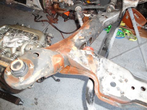 1989 Ford Taurus - A disassembled engine and subframe are shown in a workshop setting.