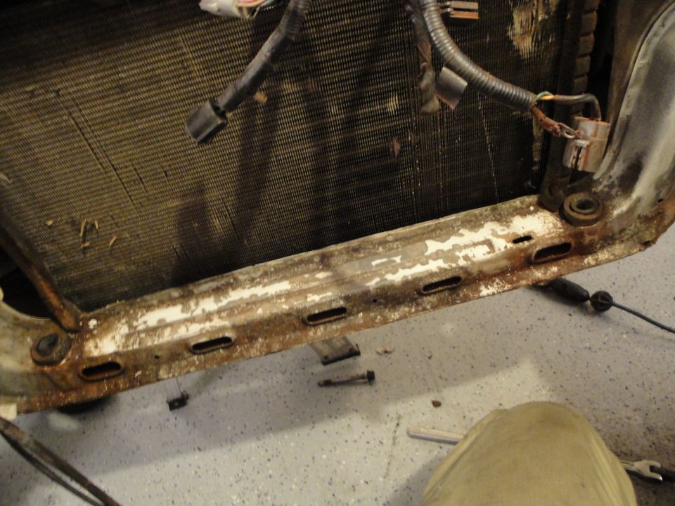 Radiator assembly with wiring harness and rusted mounting bracket