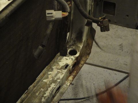 1989 Ford Taurus - A close-up view of a vehicle's frame and wiring, showing signs of rust and wear.