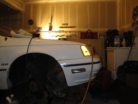 1989 Ford Taurus - Front quarter view of a 1989 Ford Taurus undergoing service in a garage.